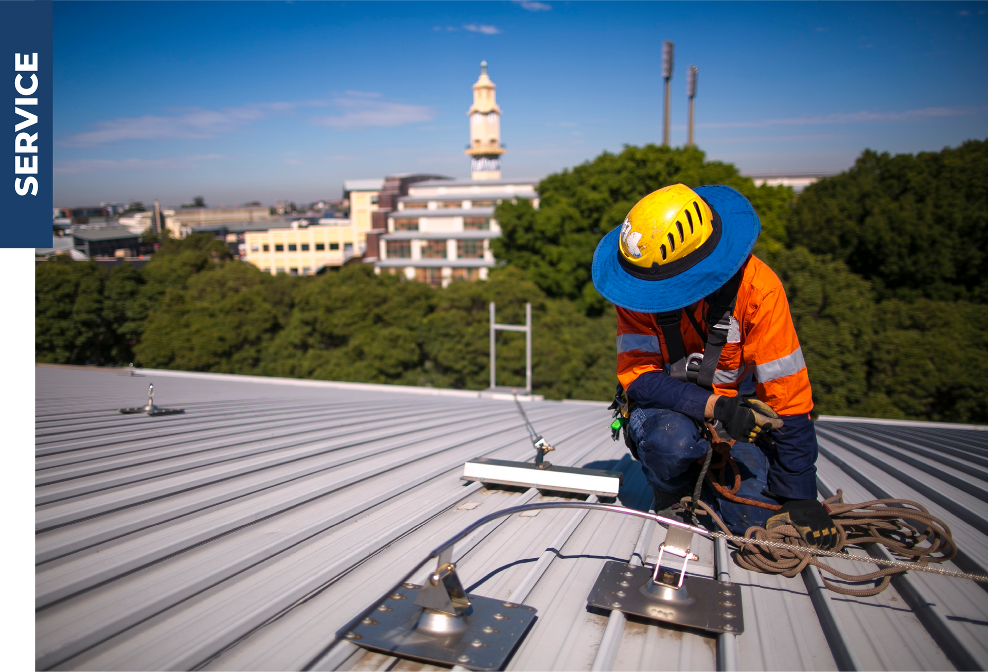 A man is working on the roof of a building.