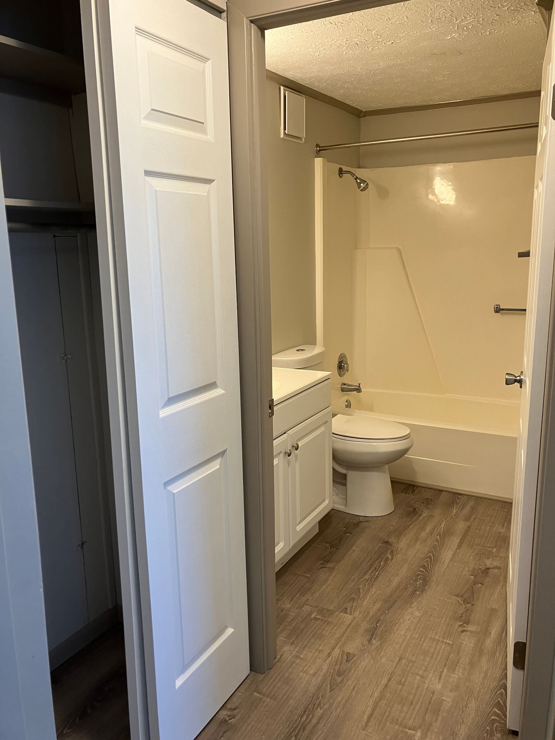A bathroom with a toilet , sink , and bathtub.