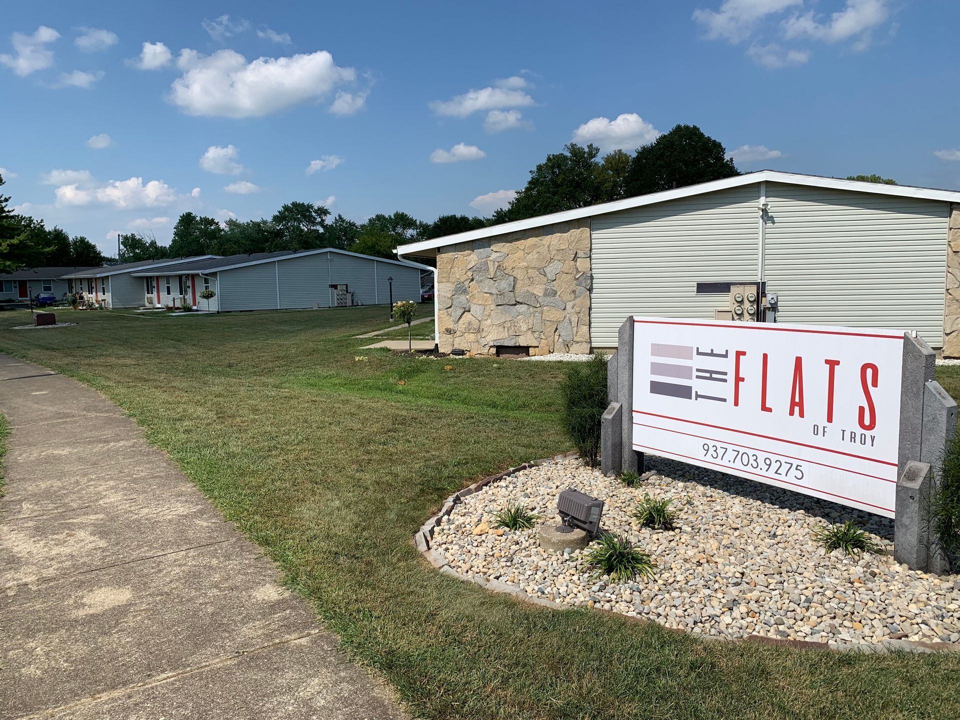 A sign in front of a building that says flats