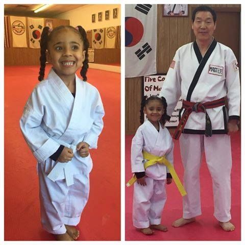 A person is holding a sparkler in their hand in the dark.