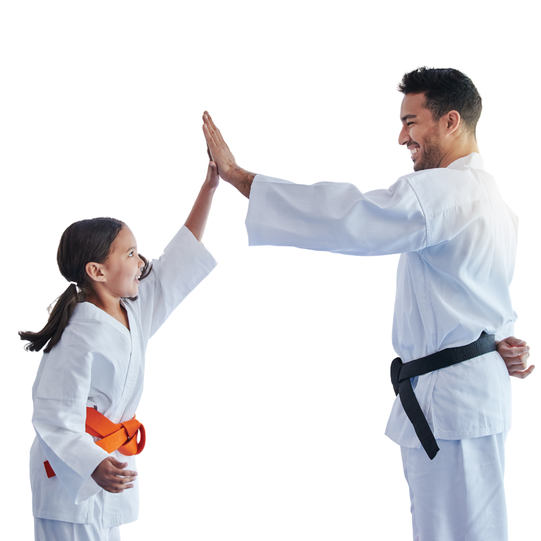 A man and a woman are standing next to a young boy in karate uniforms