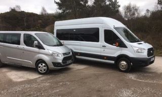 a silver van and a white minibus