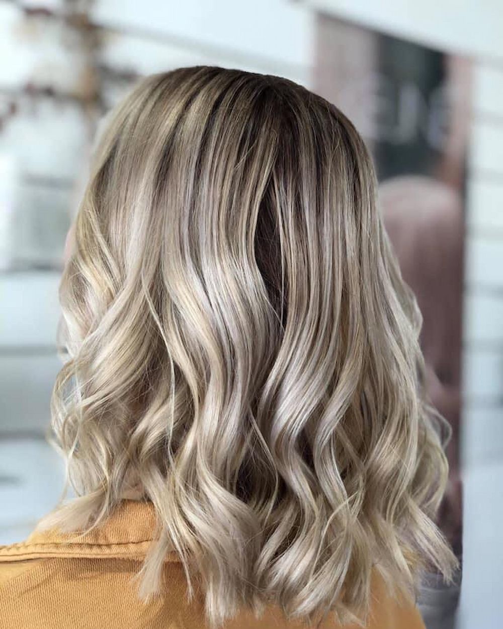 Shoulder-length Blonde Wavy Hair With Dark Roots — Strut Hair & Beauty In Maroochydore, QLD