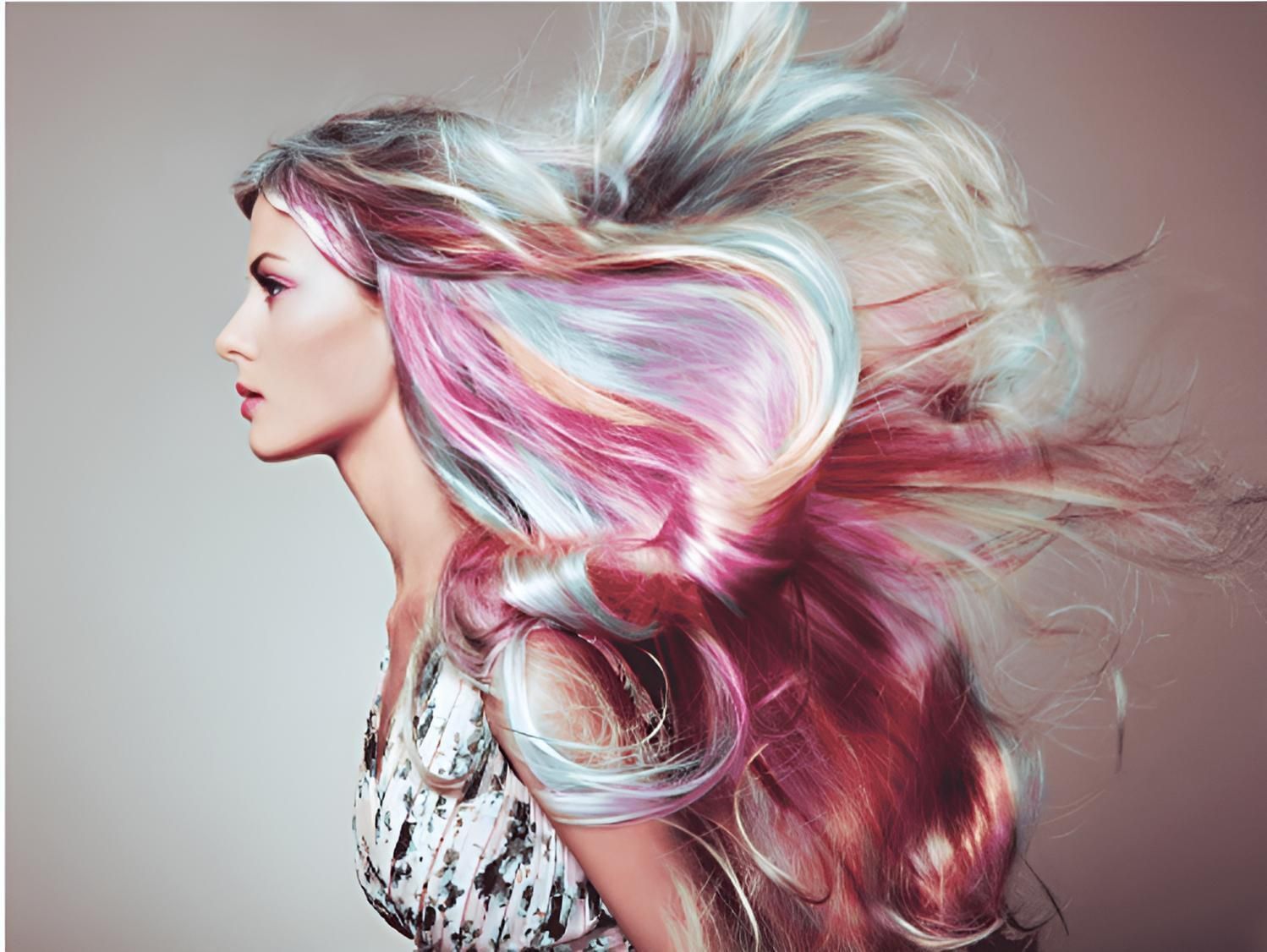 A Woman With Long Colorful Hair is Blowing in the Wind — Strut Hair & Beauty In Maroochydore, QLD