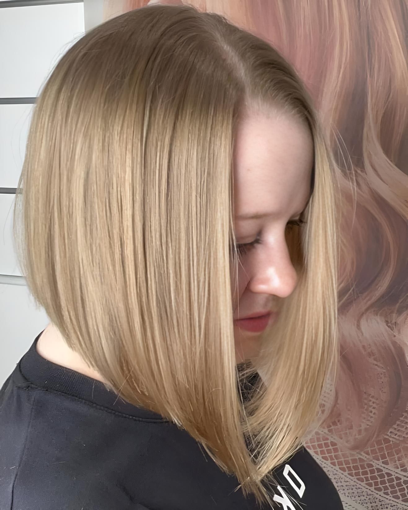 A Woman With Blonde Hair is Wearing a Black Shirt — Strut Hair & Beauty In Maroochydore, QLD