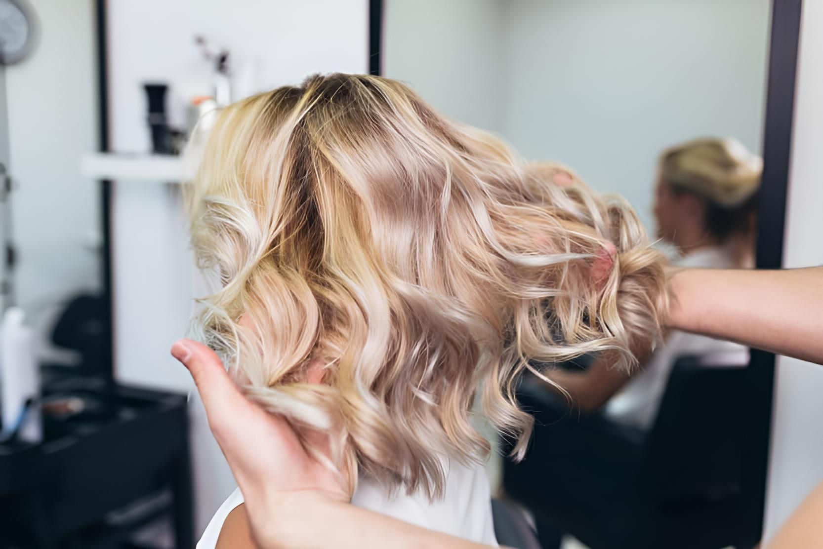 A Woman is Getting Her Hair Done by a Hairdresser in a Salon — Strut Hair & Beauty In Maroochydore, QLD