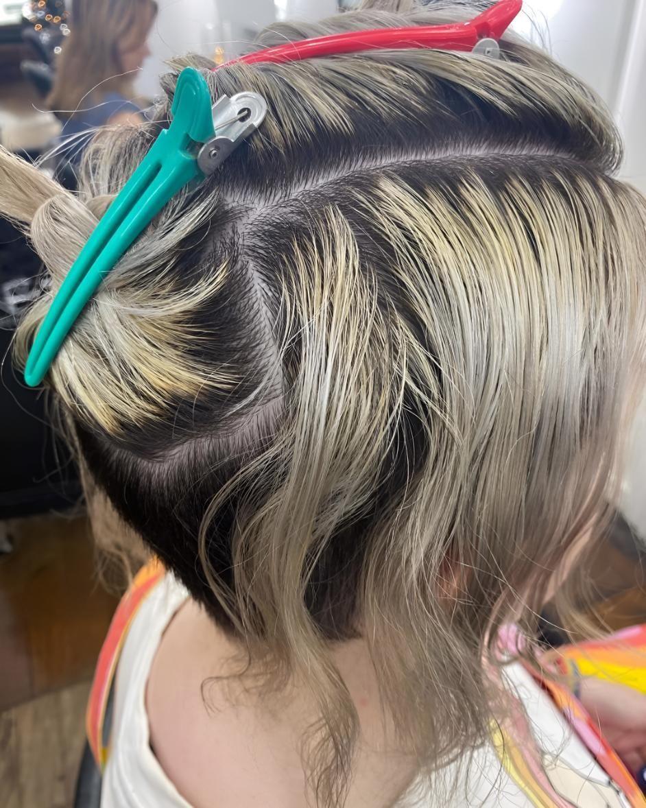 A Woman With Blonde Hair is Wearing a Black Shirt — Strut Hair & Beauty In Maroochydore, QLD