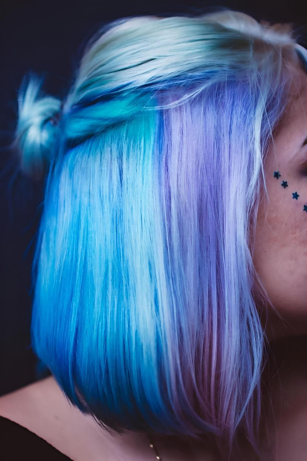 A Woman With Blue and Purple Hair Has a Tattoo on Her Face — Strut Hair & Beauty In Maroochydore, QLD