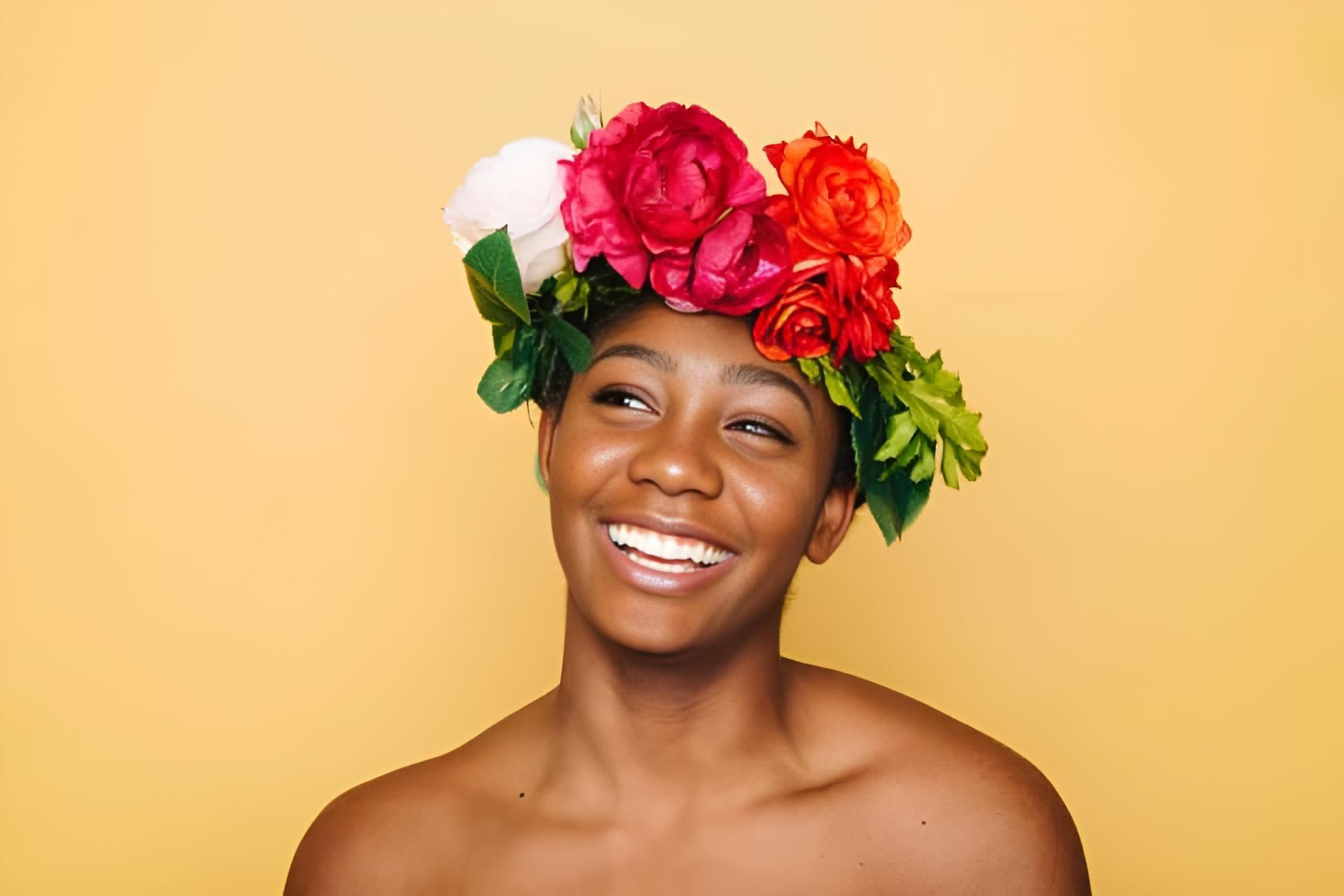 A Woman is Wearing a Flower Crown on Her Head and Smiling — Strut Hair & Beauty In Maroochydore, QLD