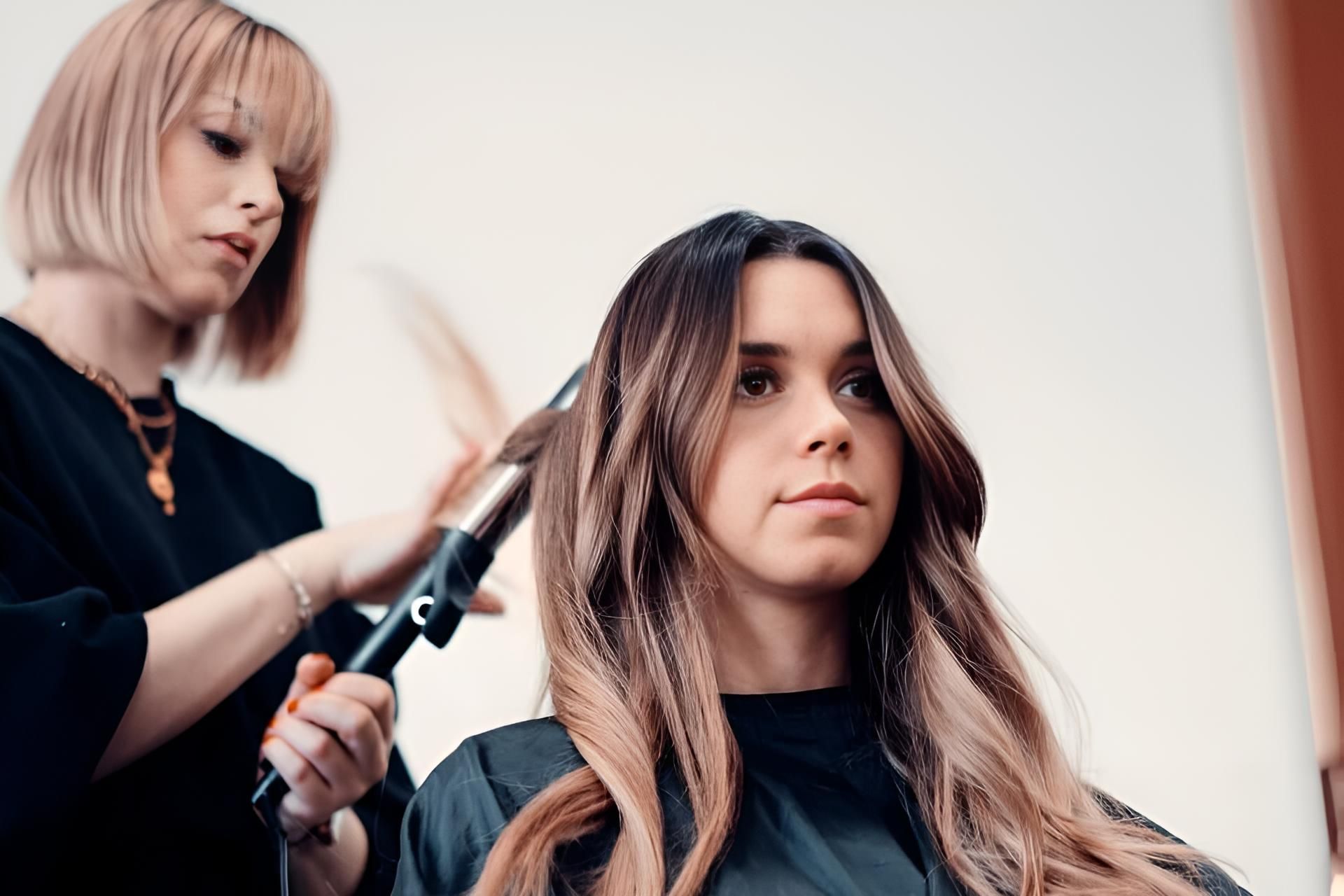 A Woman is Getting Her Hair Done by a Hairdresser in a Salon — Strut Hair & Beauty In Maroochydore, QLD