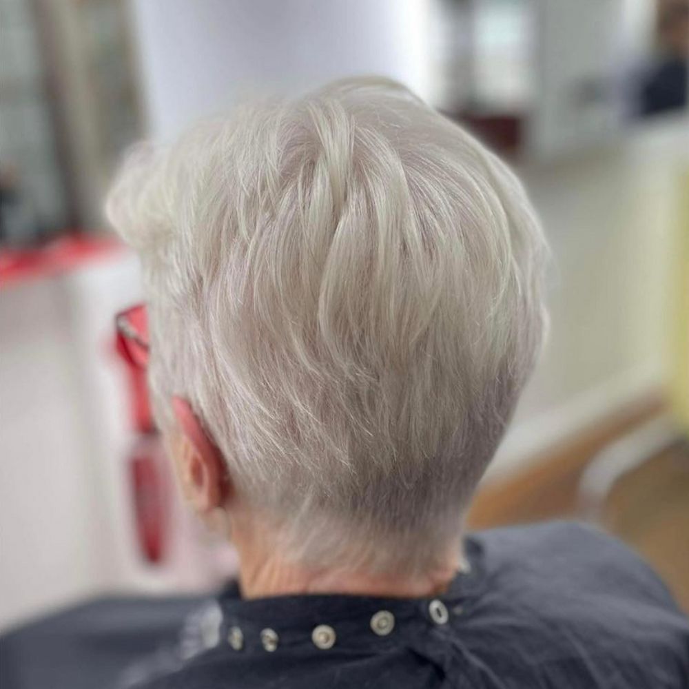 Back View of a Woman With Short, Textured, Gray Hair and a Black Smock in a Salon — Strut Hair & Beauty In Maroochydore, QLD
