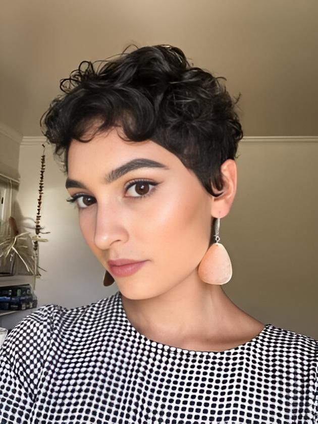 A Woman With Short Curly Hair and Earrings is Taking a Selfie — Strut Hair & Beauty In Maroochydore, QLD