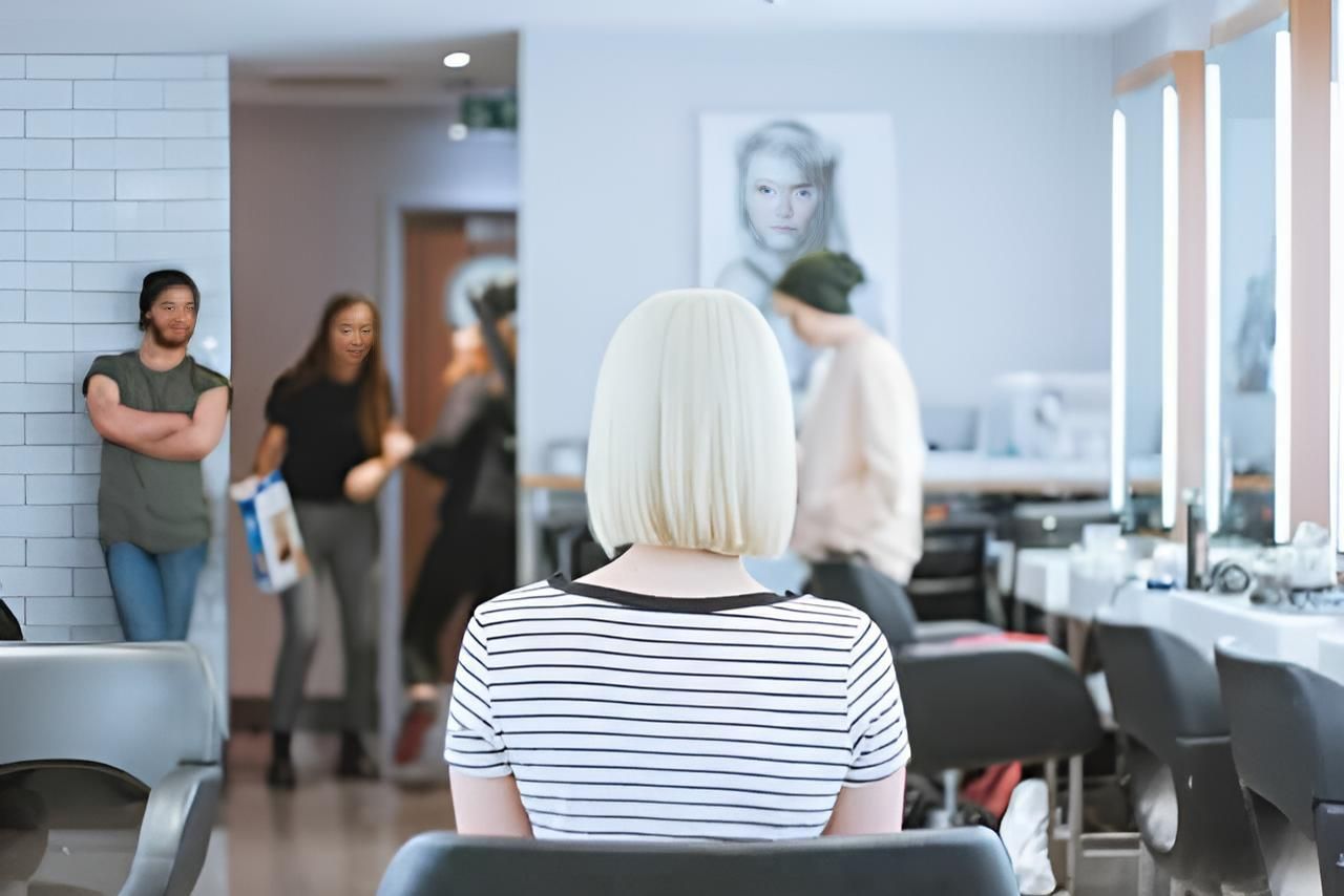 A Woman is Sitting in a Chair in a Hair Salon — Strut Hair & Beauty In Maroochydore, QLD
