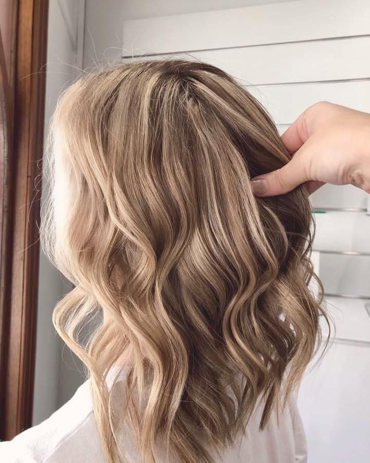 A Woman is Getting Her Hair Done by a Hairdresser — Strut Hair & Beauty In Maroochydore, QLD