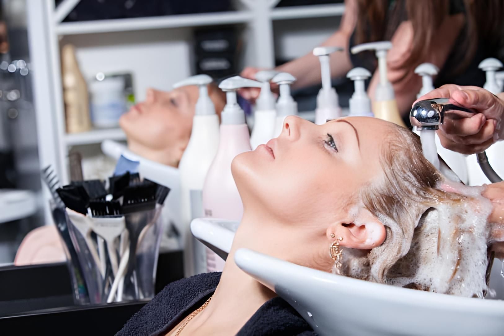 A Woman is Getting Her Hair Washed in a Salon — Strut Hair & Beauty In Maroochydore, QLD