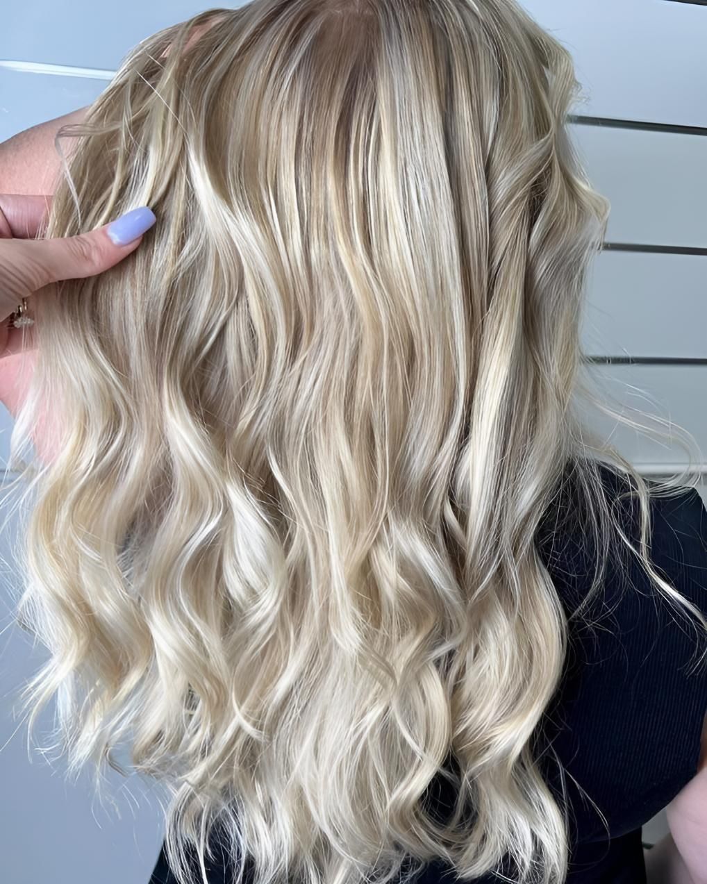 A Woman With Blonde Hair is Wearing a Black Shirt — Strut Hair & Beauty In Maroochydore, QLD