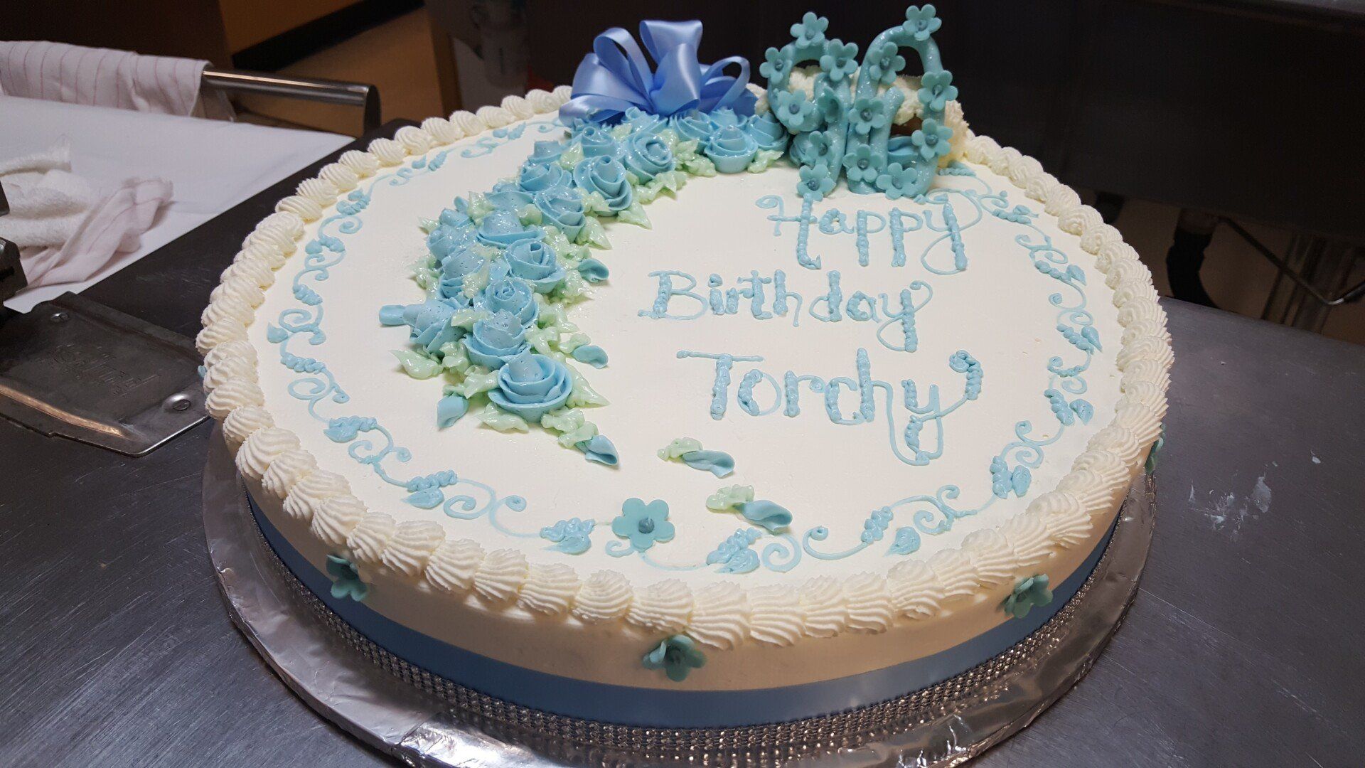 a birthday cake with blue frosting and the name terry on it