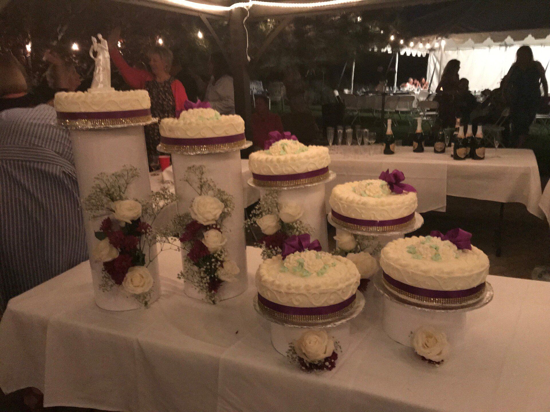 a table with a bunch of wedding cakes on it