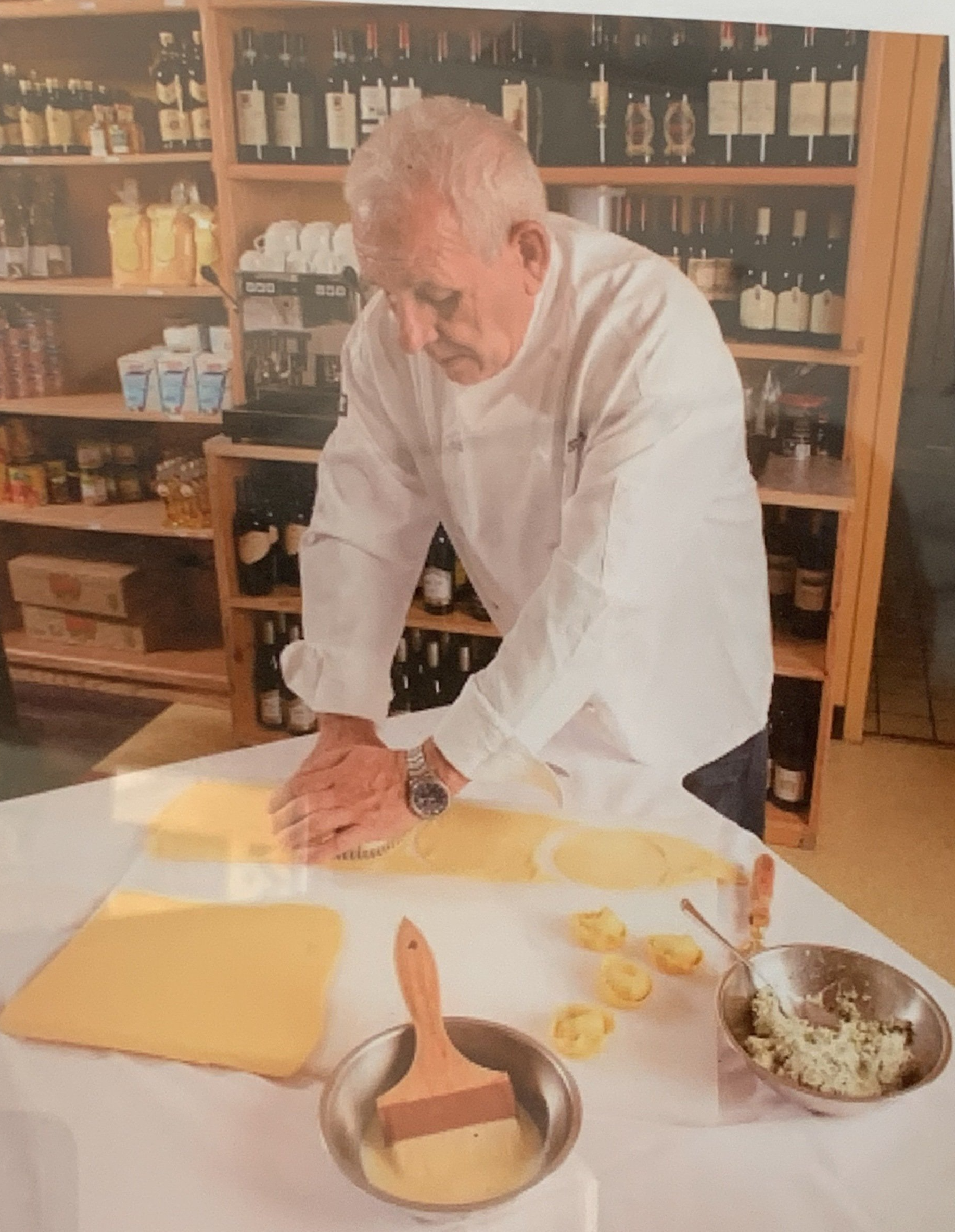 a man in a white shirt is preparing food on a table