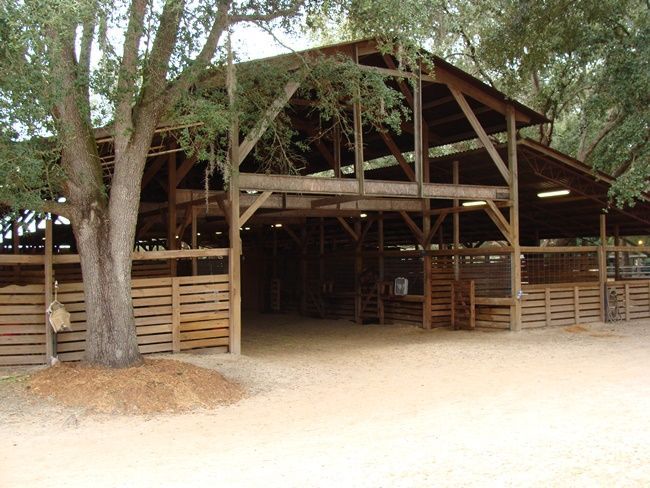 A barn is lit up at night with a sign that says welcome to