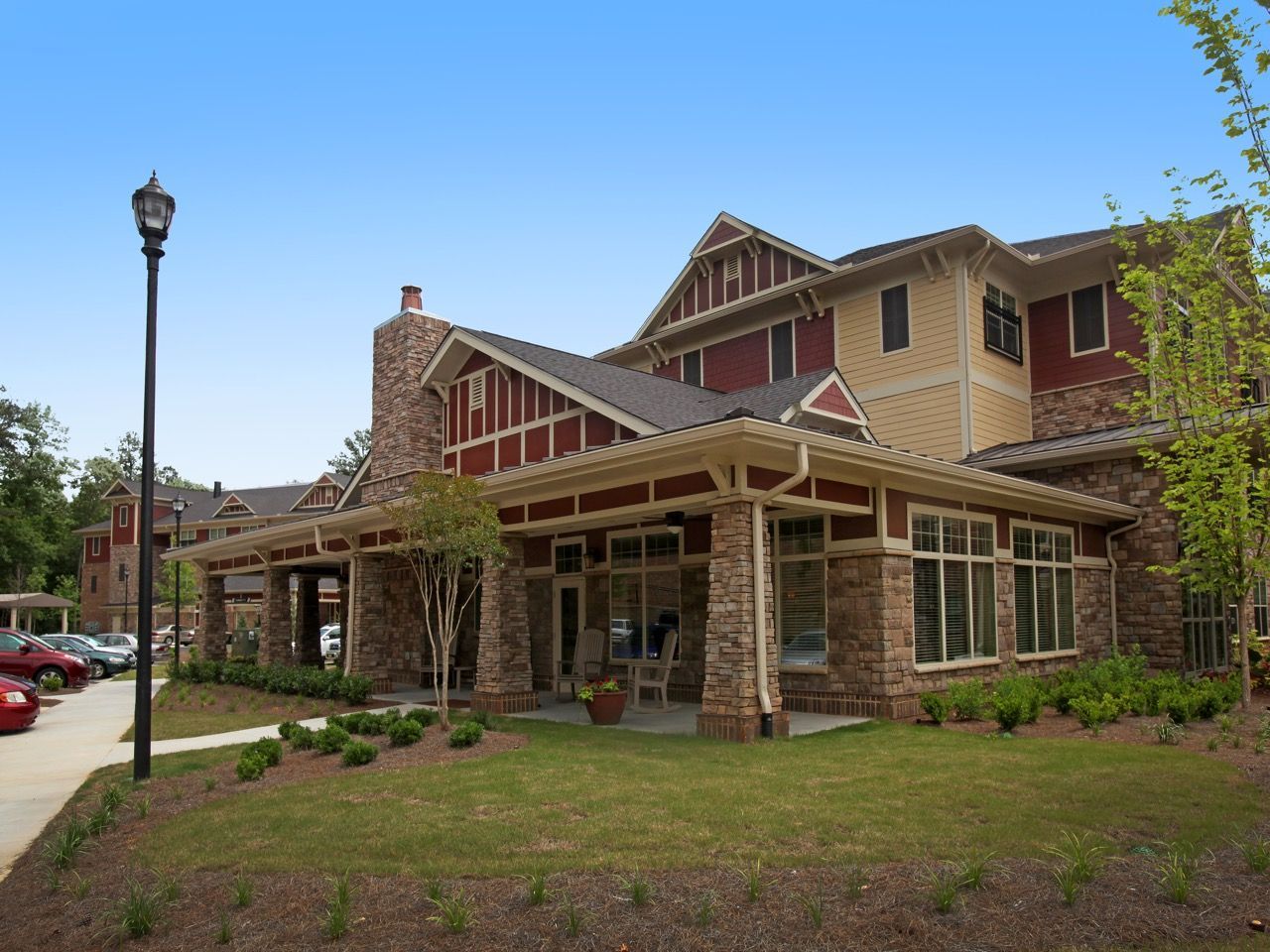 Exterior view of a multi-building apartment community with a covered entrance and stone accents.