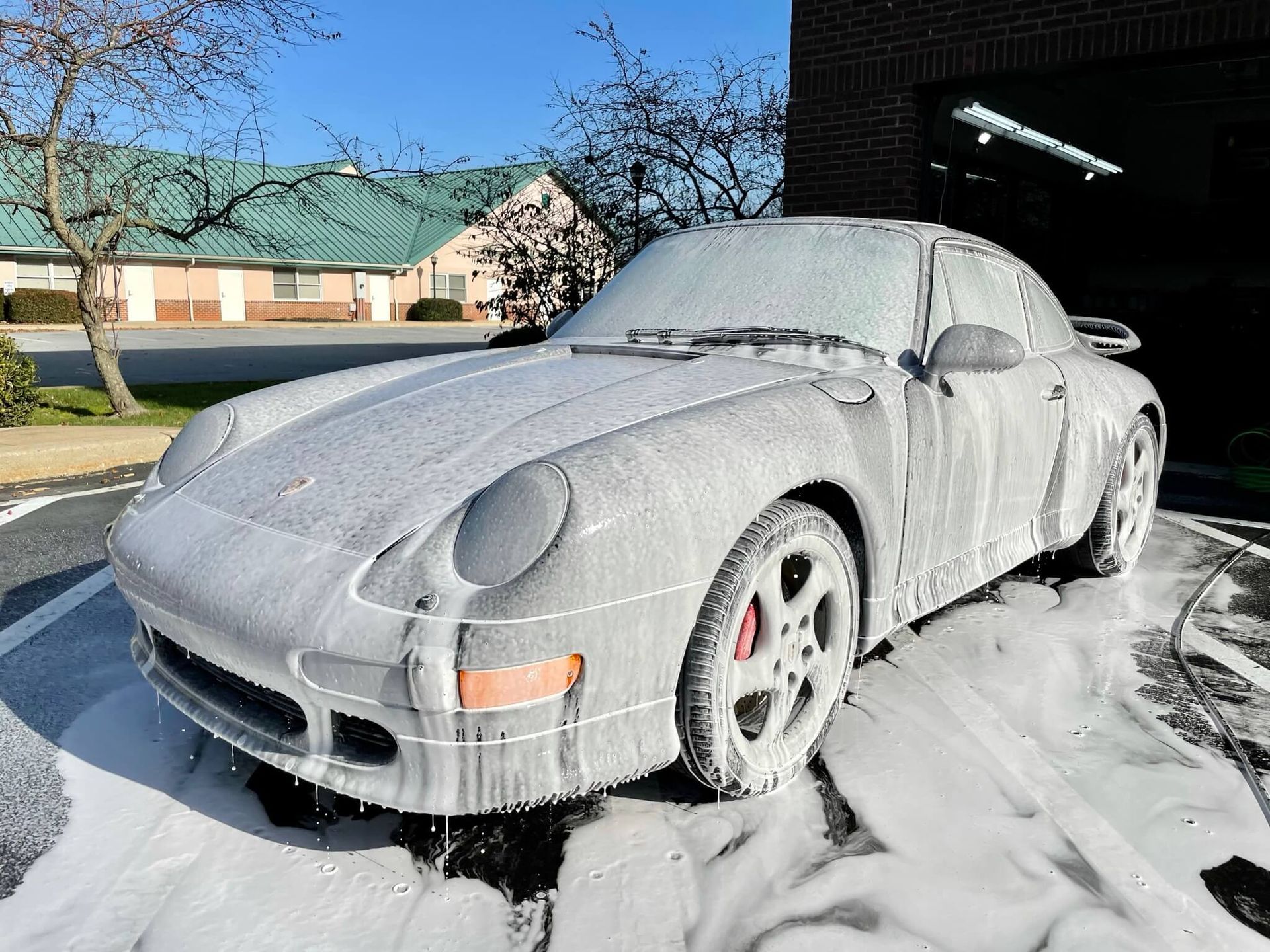 A person wearing black gloves is touching a tire