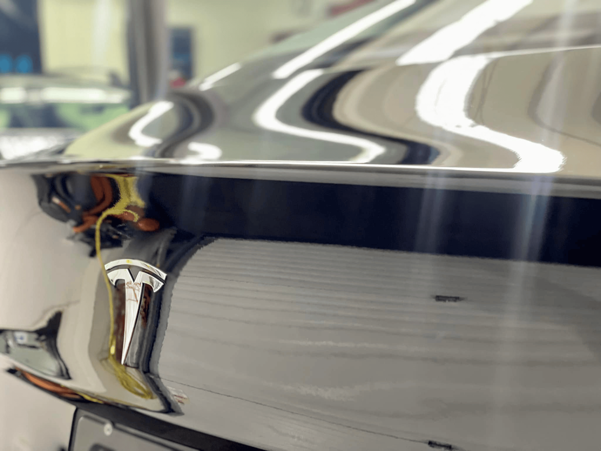 A person wearing black gloves is touching a tire