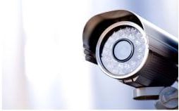 A close up of a security camera on a white background.