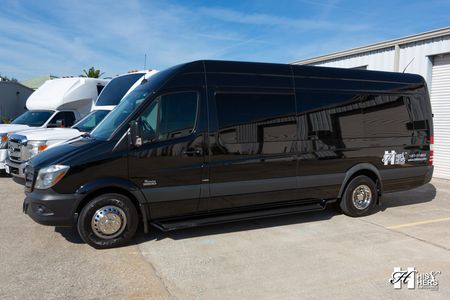 A black mercedes benz sprinter van is parked on a white background.