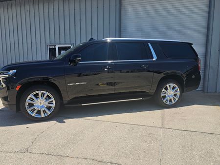 A black cadillac escalade is shown on a white background.