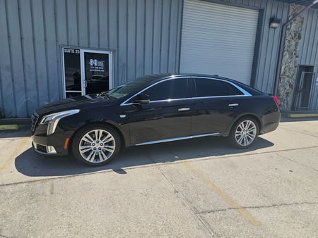 A black cadillac escalade is shown on a white background.
