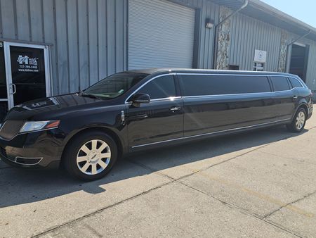 A black limousine is sitting on a white background.
