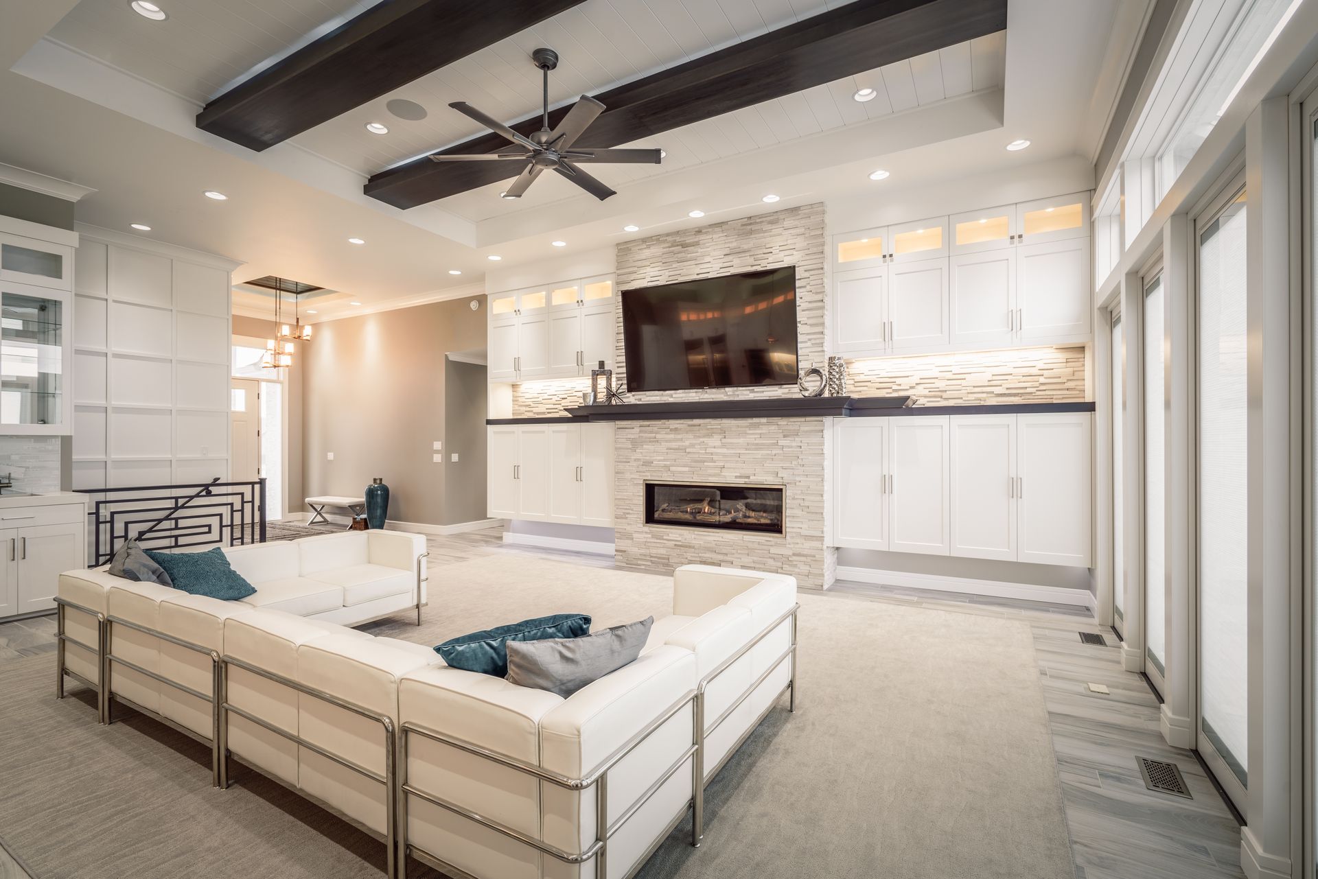 Modern living room with white sofa, fireplace, and TV.