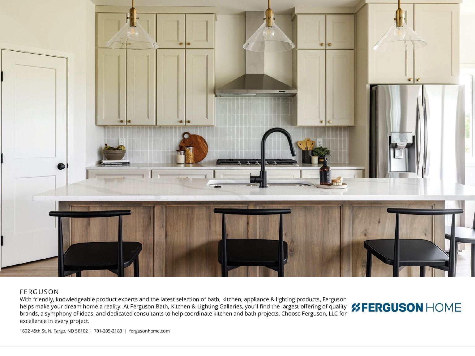 Modern kitchen with light cabinets, wood island, and stainless steel appliances.