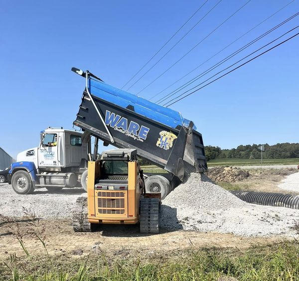 Construction worker in a vehicle wearing a hard hat, safety vest, and safety glasses. Construction worker in a vehicle wearing a hard hat, safety vest, and safety glasses.