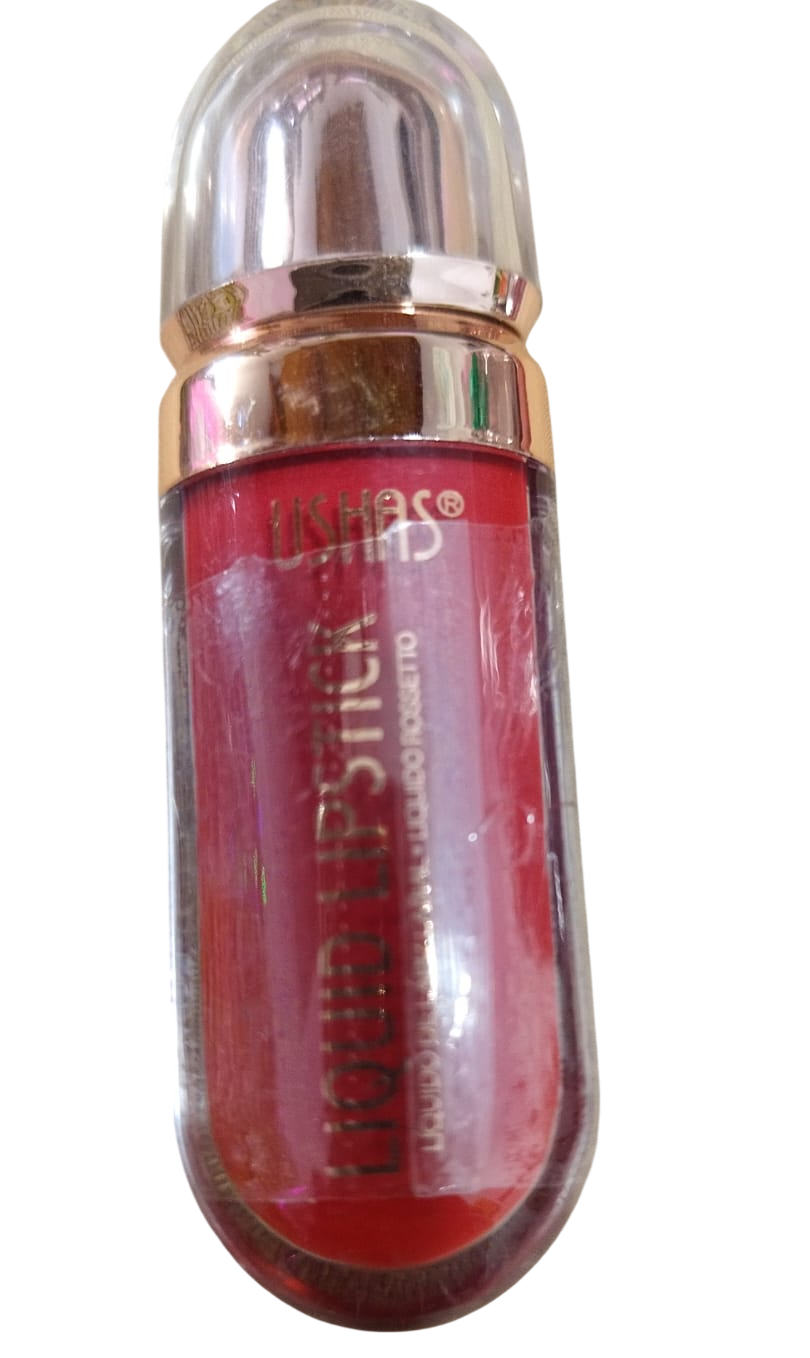 Tubo de pintalabios rojo con tapa transparente, detalles dorados y texto de la marca visible.
