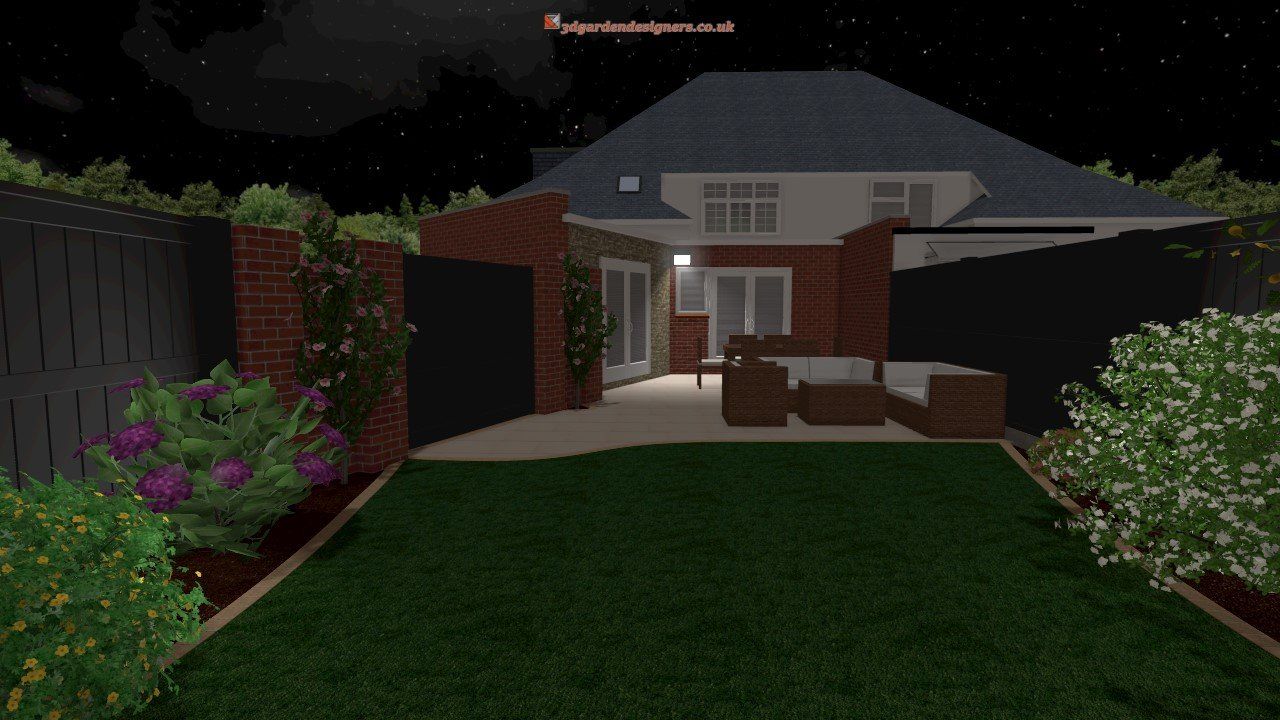 A backyard with a brick house and a patio at night.