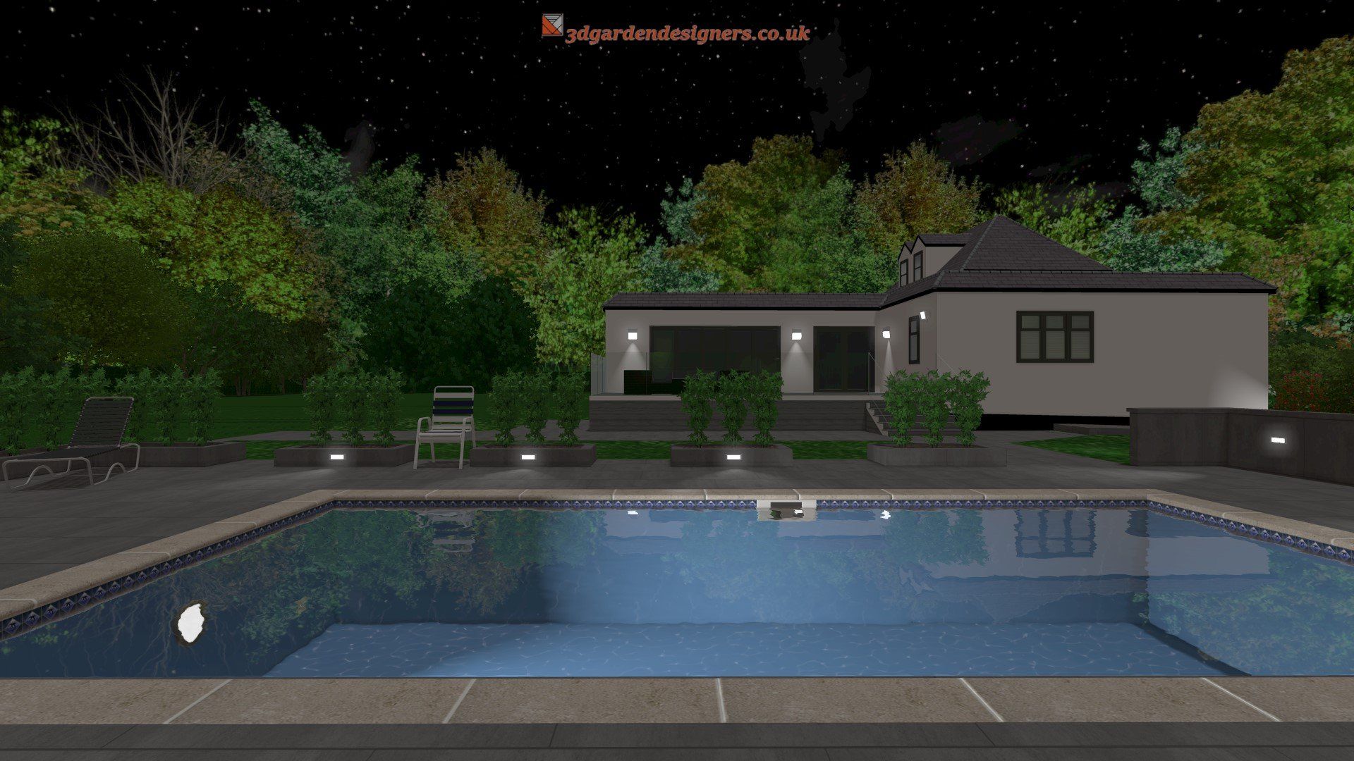A large swimming pool is in front of a house at night.