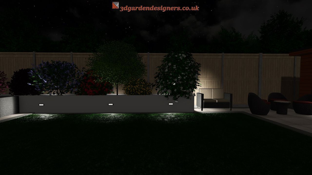 Nighttime backyard scene with lit bushes in a planter box, and a wooden fence.