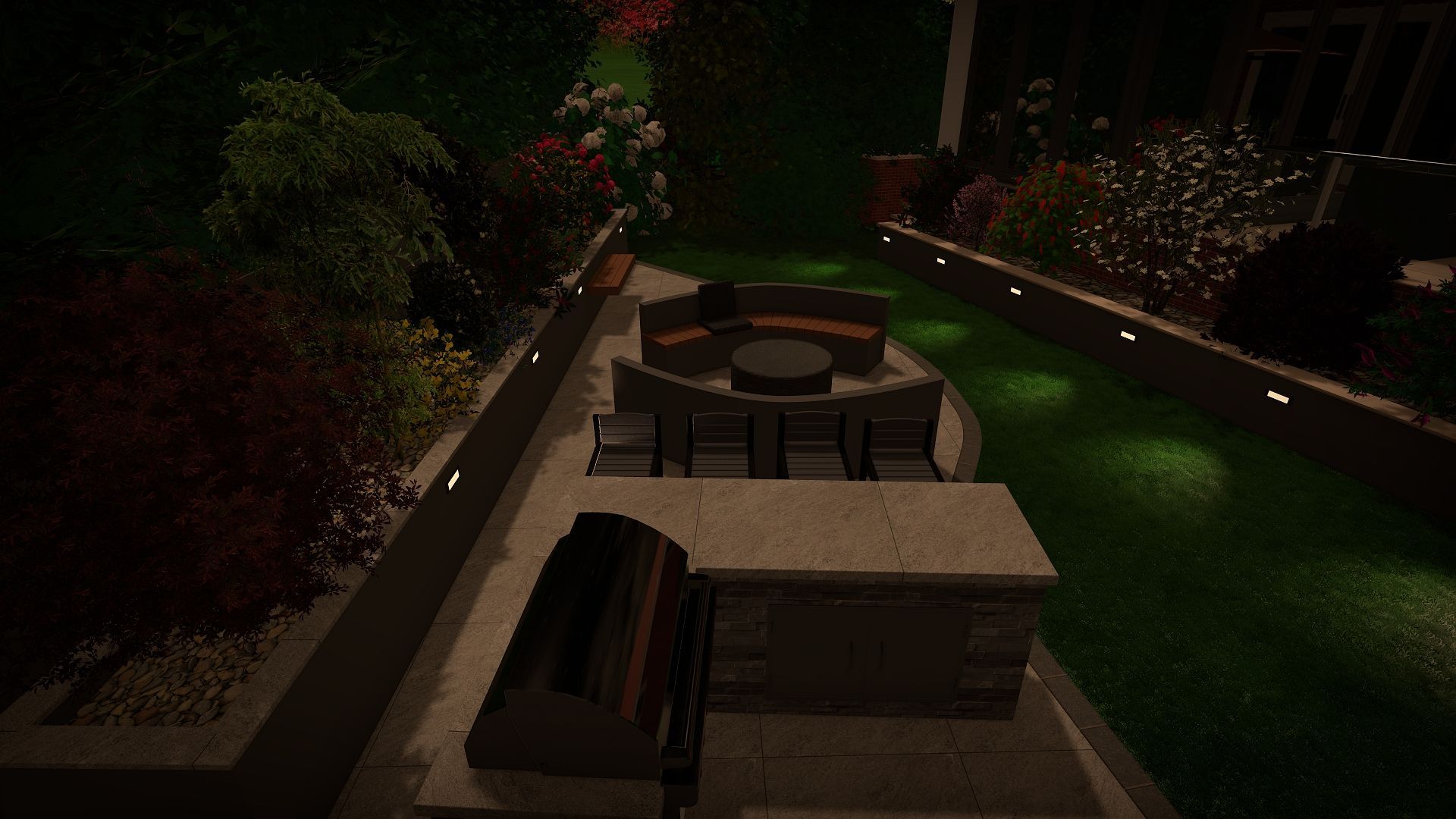 Nighttime backyard patio with seating, built-in grill, and landscaped borders lit by spotlights.