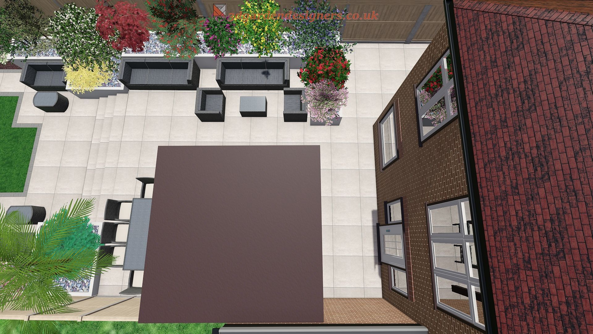 Overhead view of a patio with furniture, greenery, and a brick building with windows.