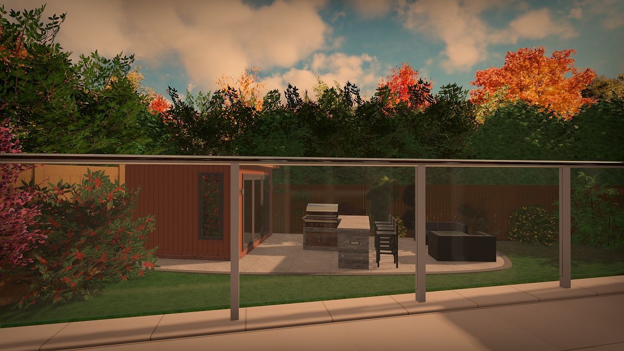 Backyard patio with glass railing, grill, and fall foliage.