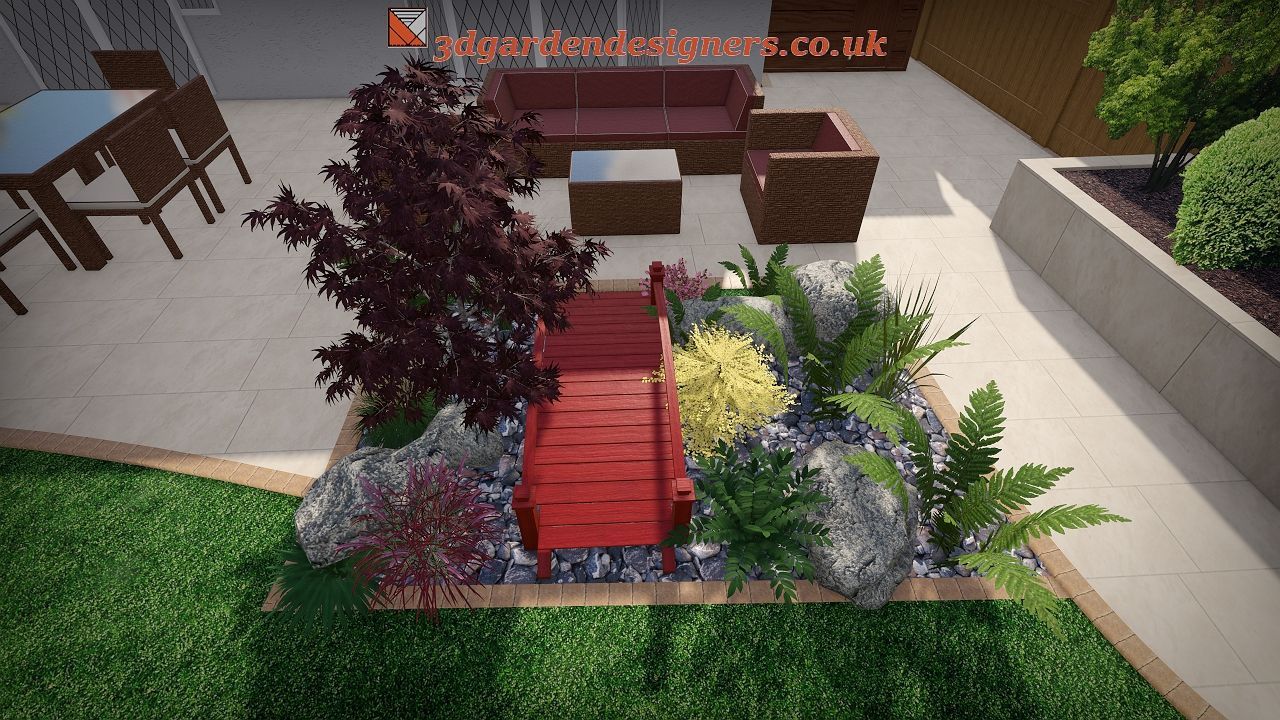 A backyard patio with a red bridge over a rock and plant garden. Brown furniture, trees, and grass.