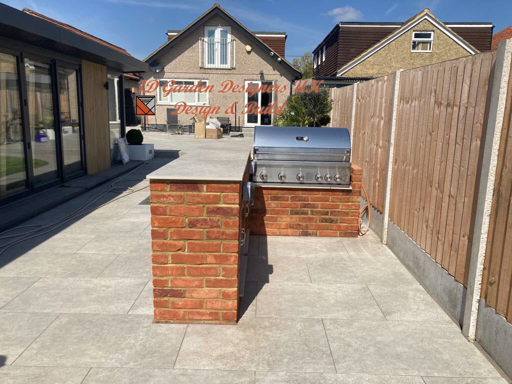 A brick grill is sitting on a patio in front of a house.