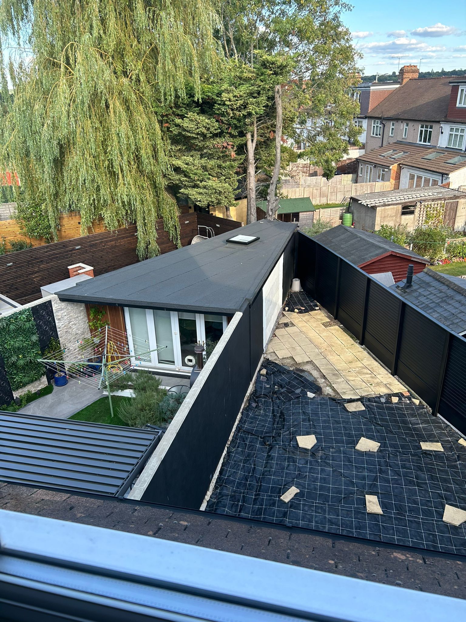 An aerial view of a house with a roof that is being repaired.