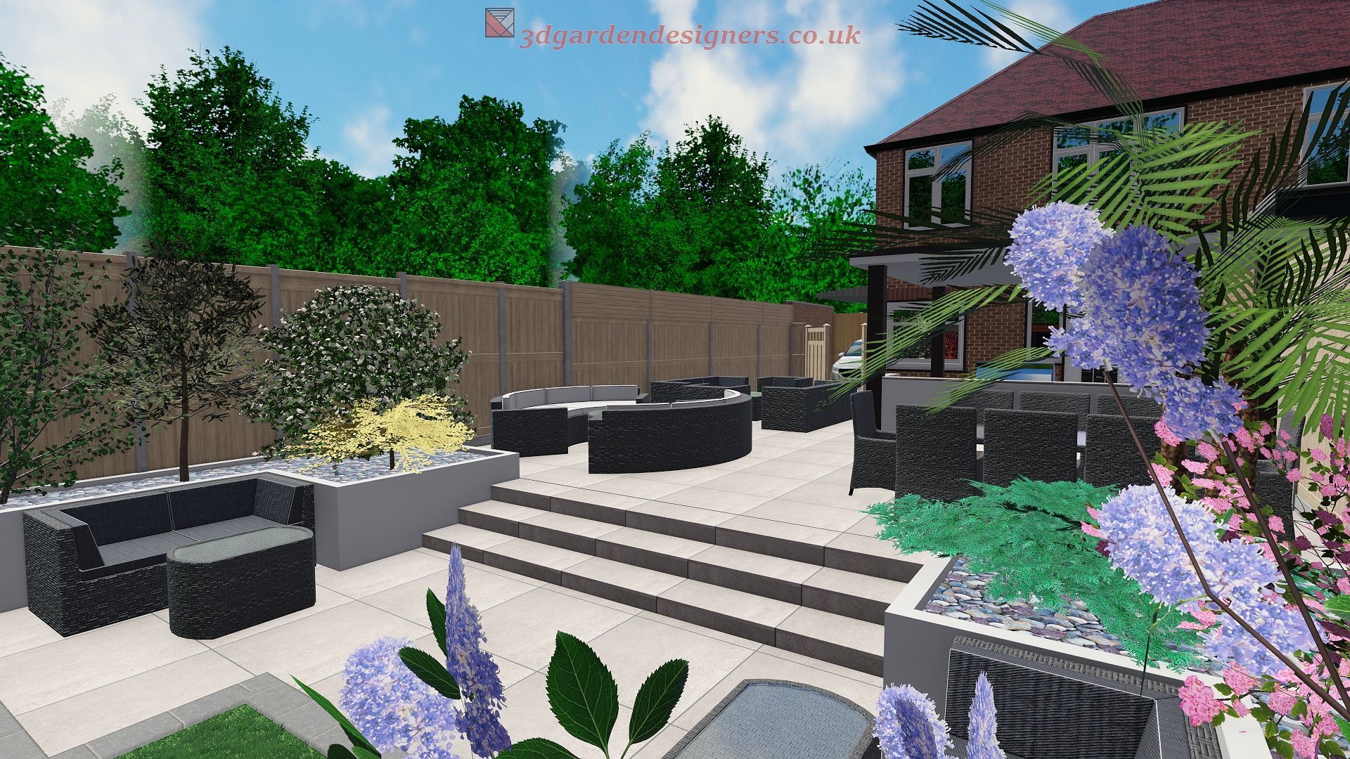 A backyard patio with seating areas, steps, and landscaping. Dark furniture, green plants, and a brick house are visible.