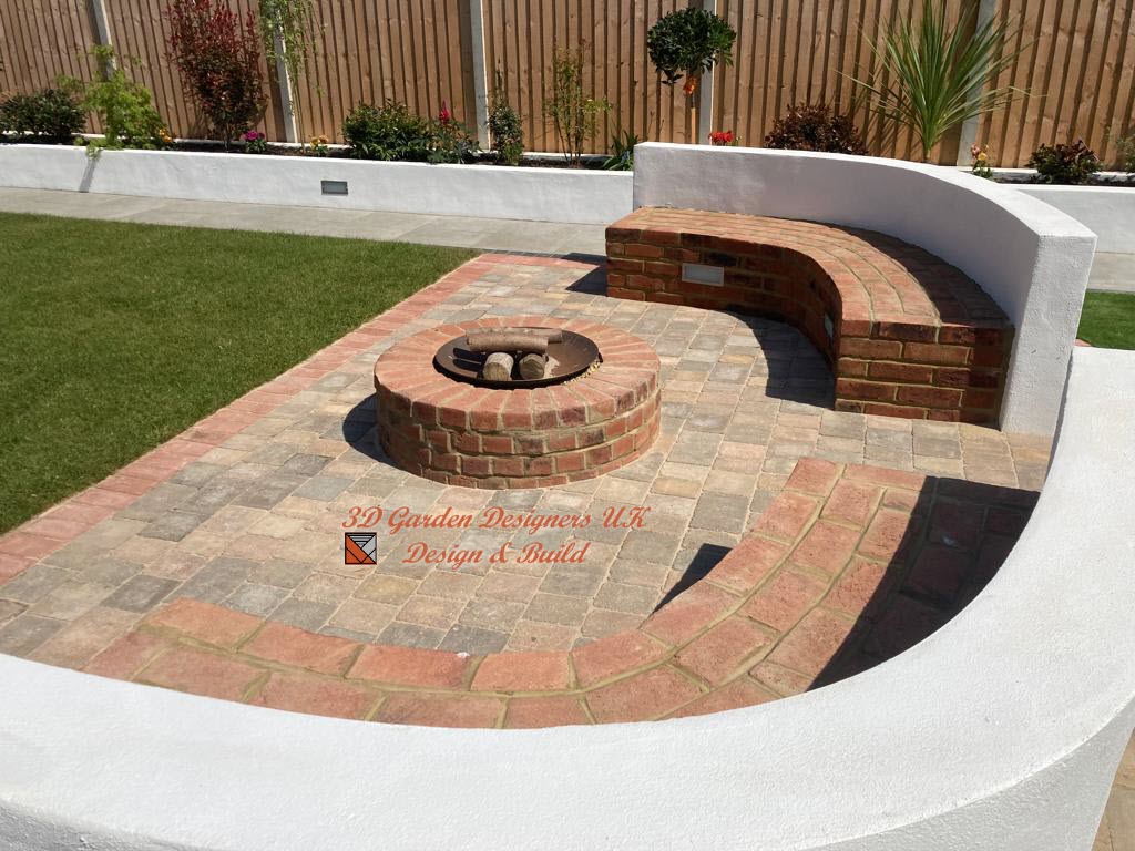 A fire pit is surrounded by bricks and a curved bench.