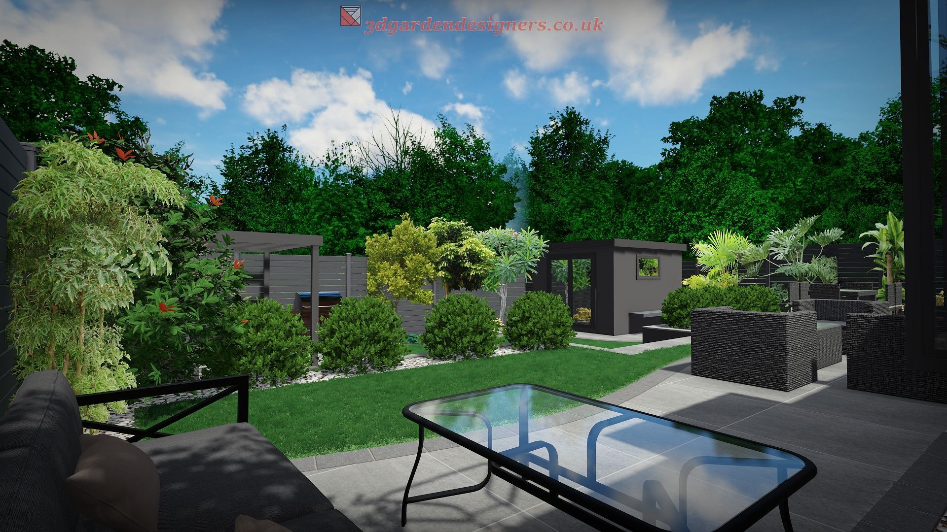 A backyard scene with a glass table on a patio, lawn, and lush greenery under a blue sky.