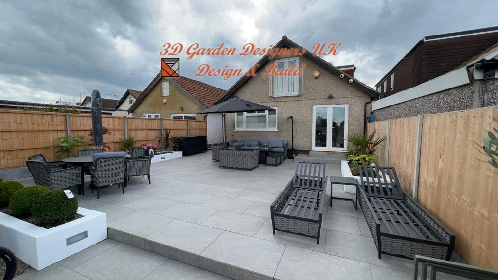 A patio with a table , chairs and umbrellas in front of a house.