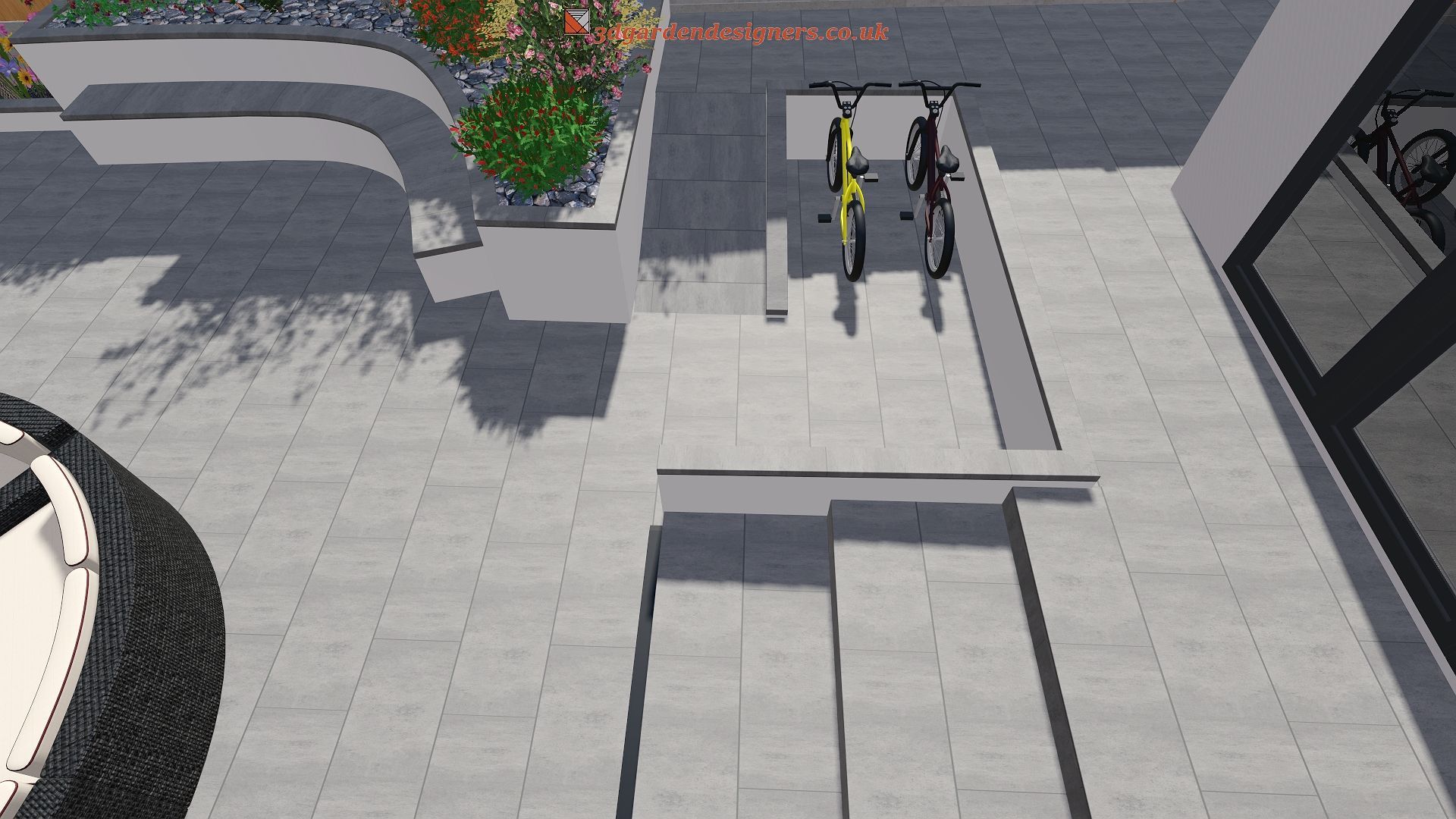 Two bicycles parked near a building entrance, gray steps, planters with greenery, and a sidewalk.